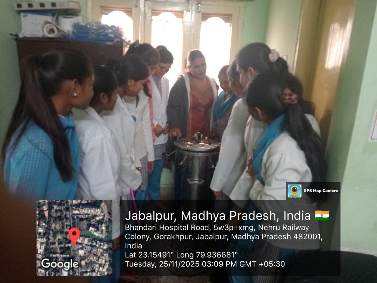 Students observing a lab demonstration in their academic uniform