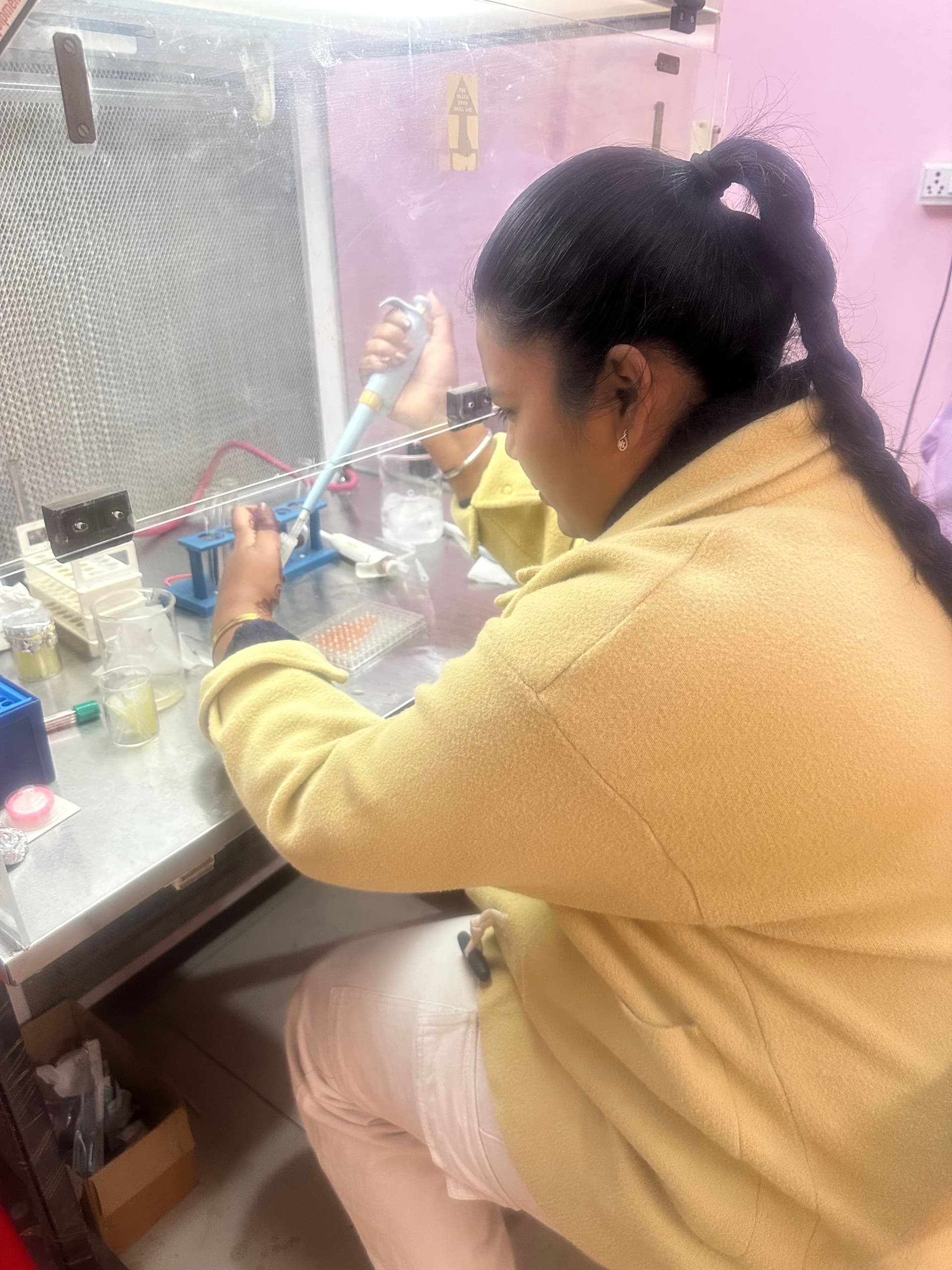 Lab personnel working in a sterile workbench environment