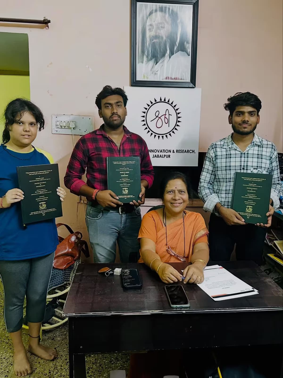 A group of people holding up books in a room