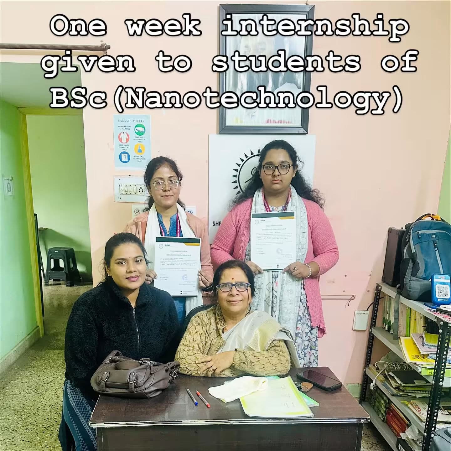 Three girls sitting at a desk with a laptop