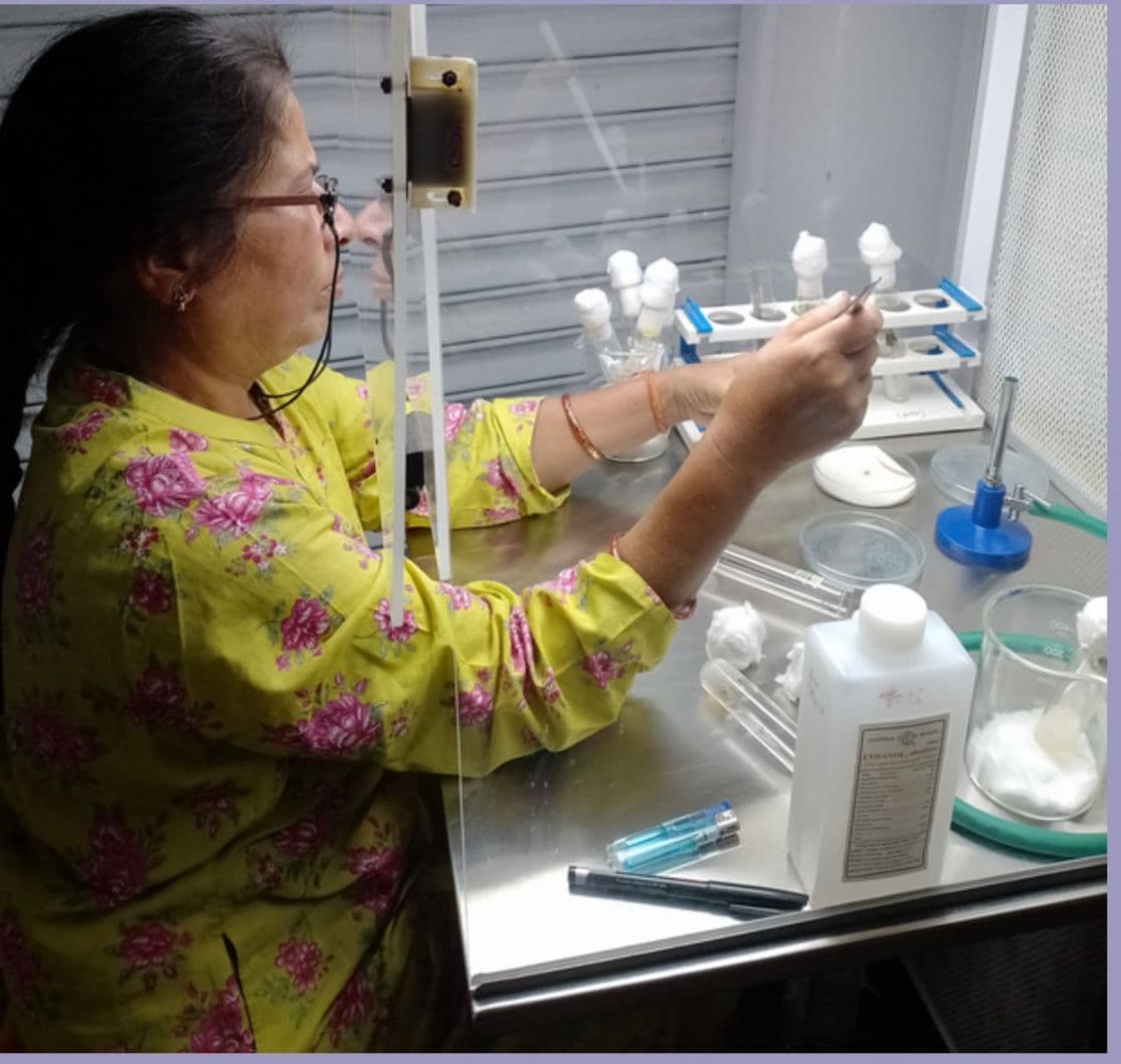 Lab scientist performing precise liquid handling with tubes